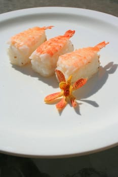 Close up of shrimp sushi on a plate.
