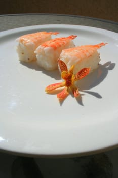 Close up of shrimp sushi on a plate.
