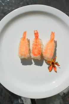 Close up of shrimp sushi on a plate.
