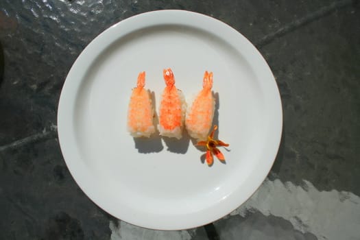 Close up of shrimp sushi on a plate.
