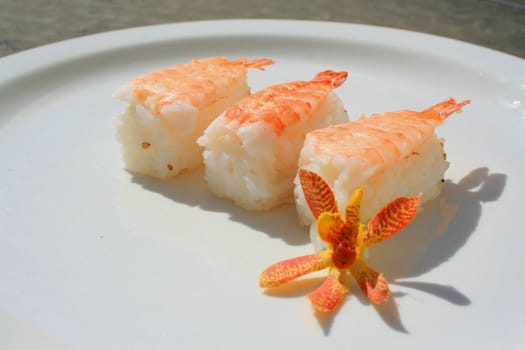 Close up of shrimp sushi on a plate.
