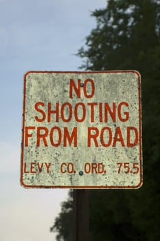 A sign in rural Florida admonishes drivers not to shoot from the road.