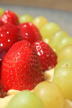 Close up of ripe strawberries and grapes.
