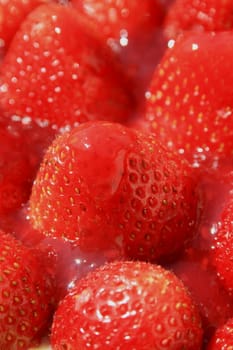 Close up of ripe strawberries in jelly.
