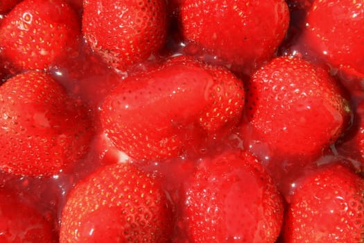 Close up of ripe strawberries in jelly.
