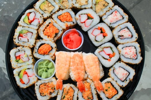 Close up of sushi assortment on a platter.
