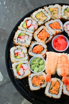 Close up of sushi assortment on a platter.
