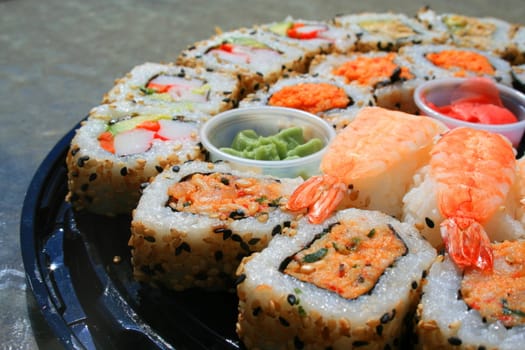 Close up of sushi assortment on a platter.
