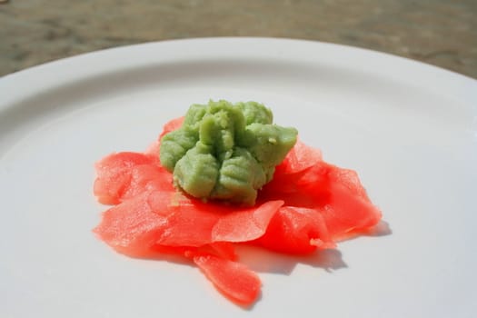 Wasabi and sushi ginger on a plate.
