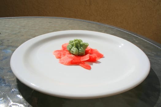 Wasabi and sushi ginger on a plate.
