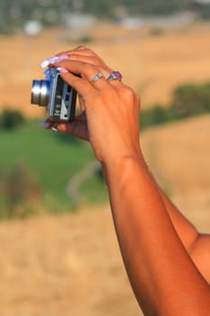 Close up of woman's hands holding digital camera.
