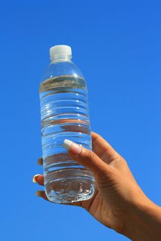 Close up of a woman's hand holding water bottle.
