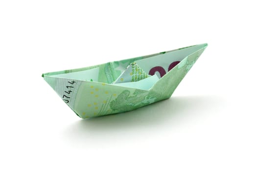 a boat folded of euro note isolated on white background