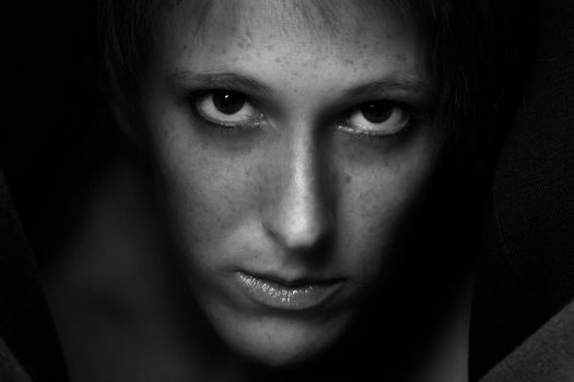 Studio portrait of a cute and beautifull girl in a turtle neck sweater staring at you