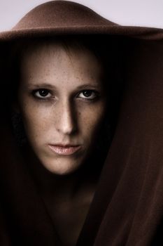 Studio portrait of a cute and beautifull girl in a turtle neck sweater looking mean