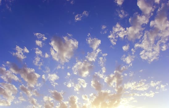 a background with a fluffy clouds and a blue sky