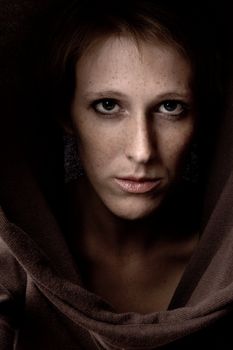 Studio portrait of a cute and beautifull girl in a turtle neck sweater making eye contact