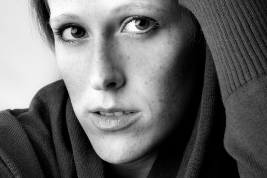 Studio portrait of a cute and beautifull girl in a turtle neck sweater paying attention