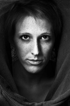 Studio portrait of a cute and beautifull girl in a turtle neck sweater concentrating