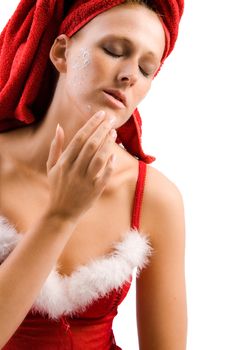 Studio portrait of a beautifull girl who is applying creme to her face