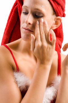 Studio portrait of a beautifull girl moisturizing her face