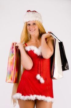Studio portrait of blond christmas girl with very long blond hair and shopping bags