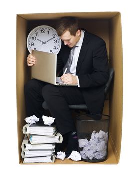 Businessman in a very tight office isolated on white background