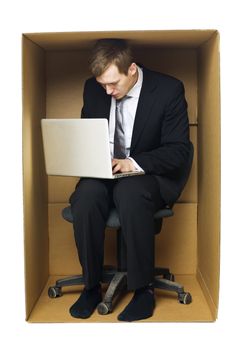 Businessman in a very tight office isolated on white background