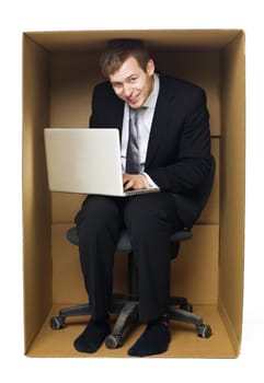 Businessman in a very tight office isolated on white background