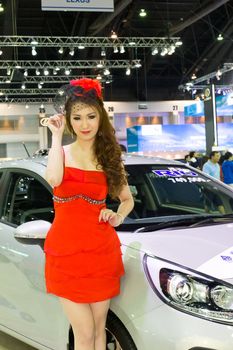 NONTABURI,THAILAND - DECEMBER 3,2011: Unidentified female presenter at KIA booth  Thailand International Motor Expo 2011 on December 3, 2011 in Nonthaburi, Thailand.