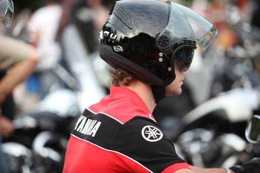 rider in a black helmet, side view, close-up