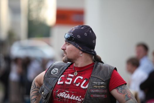man in a bandana and tattoos on his hands