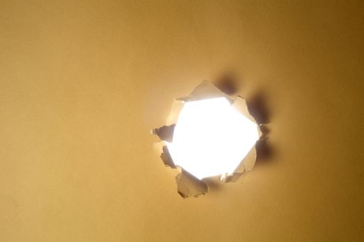stock image light throuh a hole on the paper