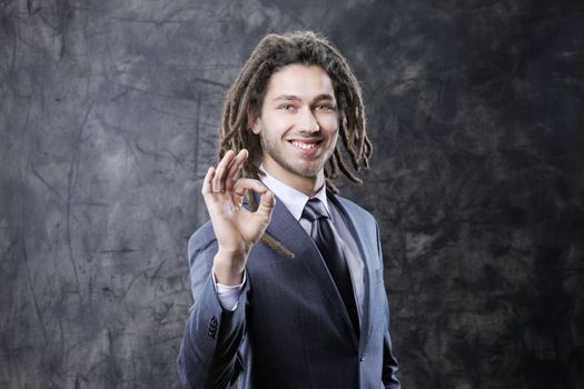 young happy businessman showing OK