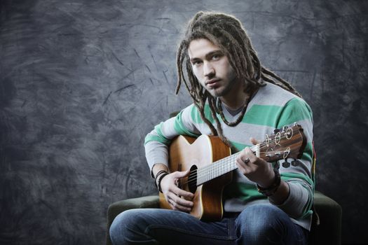 Young man playing acoustic guitar
