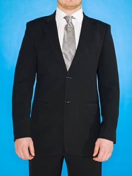 Part of a well dressed man on blue background