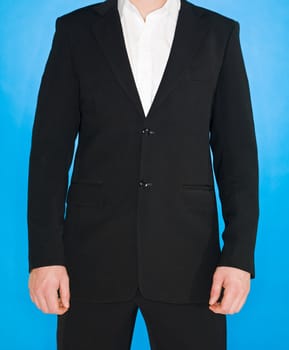 Part of a well dressed man on blue background