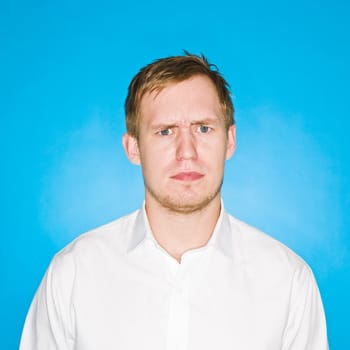 Portrait of a young man on blue background