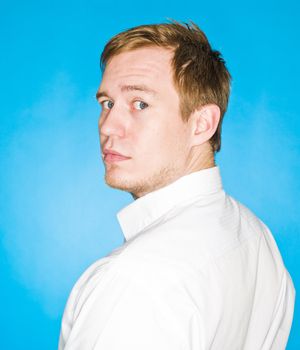 Portrait of a young man on blue background