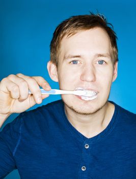 Close up of a man brushing teeths