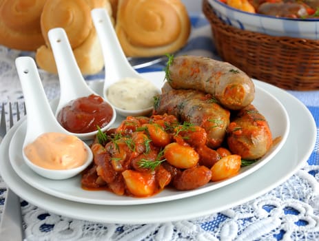 Home sausage with beans, onions and carrots in a tomato sauce