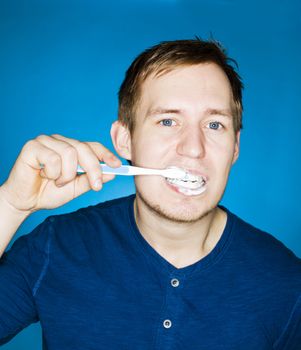 Close up of a man brushing teeths
