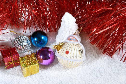 Christmas background of beautiful balls, gifts and red tinsel.