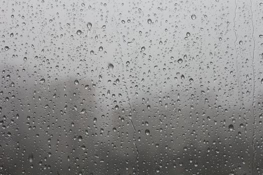 Strong rain drummed on the windowpane.
