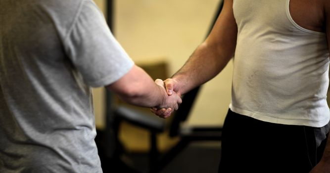 Men shaking hands in the gym