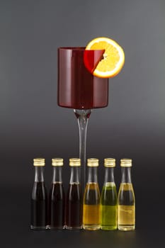 Red Liqour Glass with Orange slice and small liqour bottles