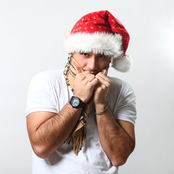 Handsome guy in christmas hat feels cold