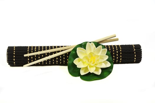 Water lily flower with bamboo rug and Chinese chopsticks