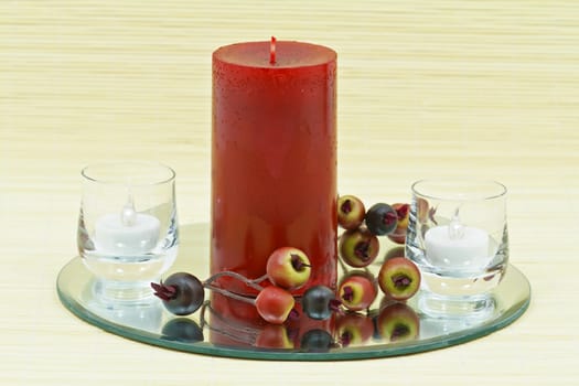 Beautiful home decoration with candle and decorative flower on small brown bamboo rug 