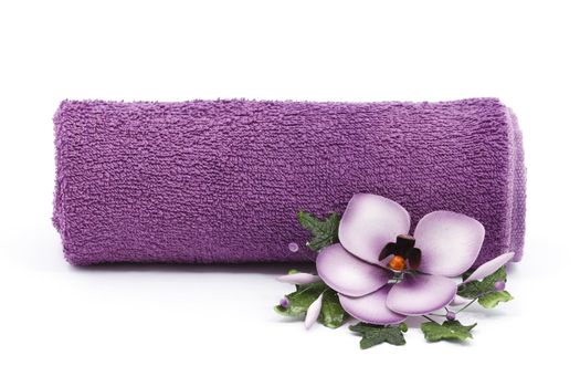 Purple towel and flower as a spa decoration isolated on white background